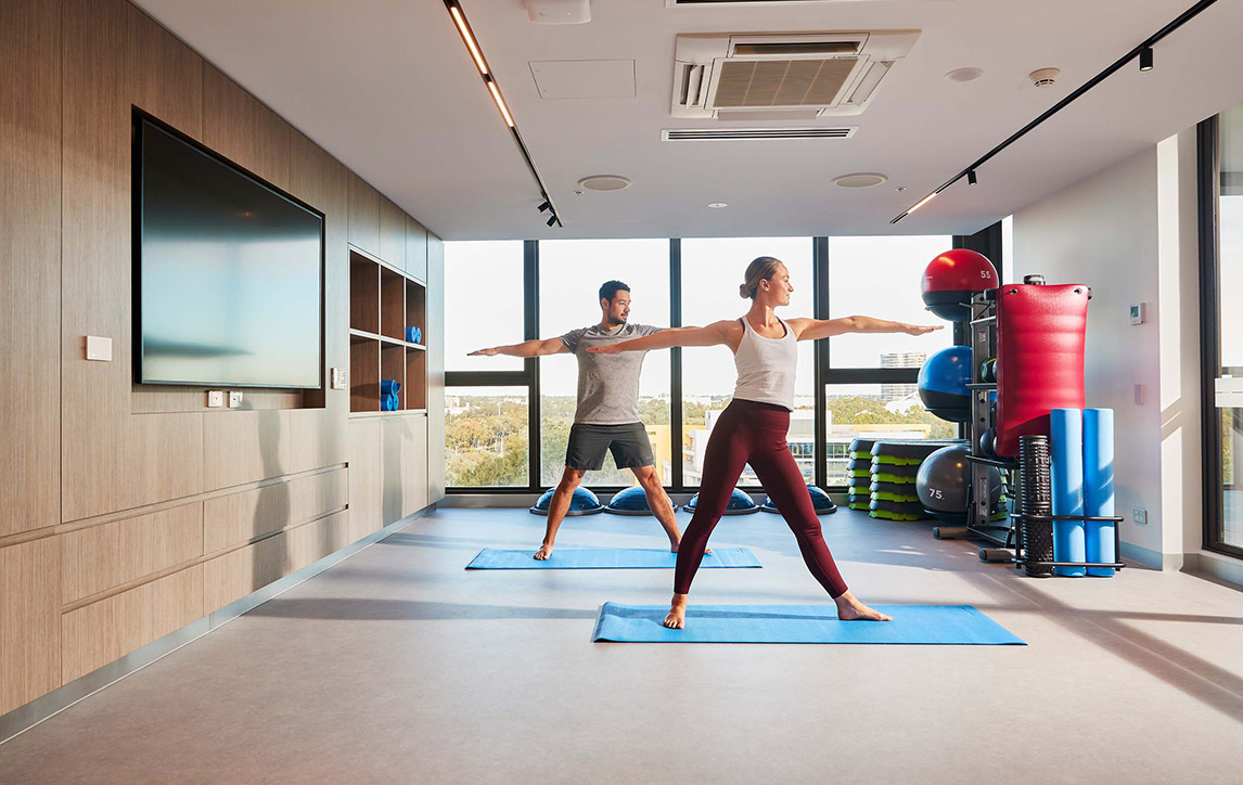 Couple doing yoga at Pavilions, Sydney Olympic Park