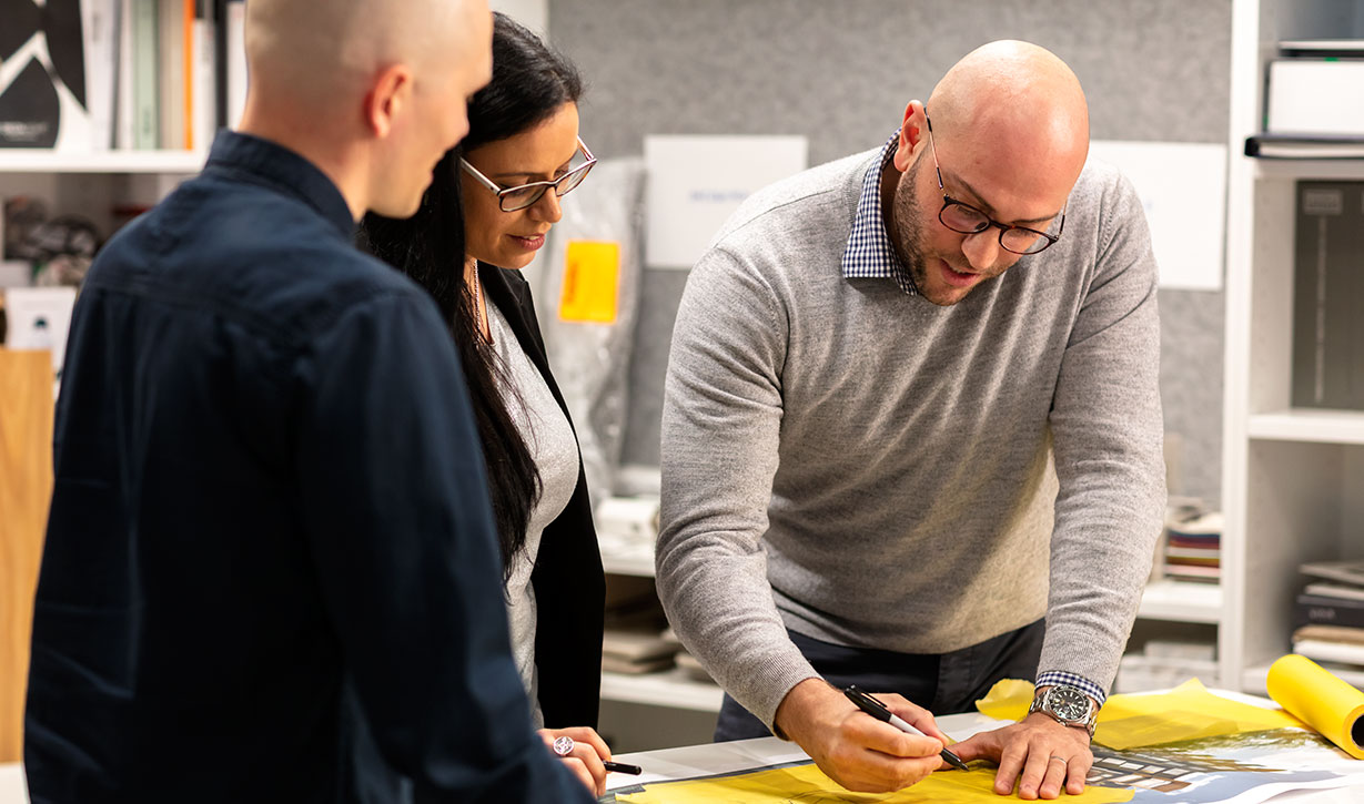 3 Mirvac design employees working on drawing