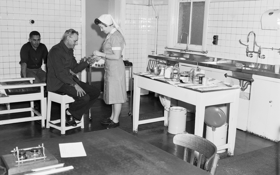 An Industrial Nurse treating worker inside the Eveleigh First Aid Room, 1960s.